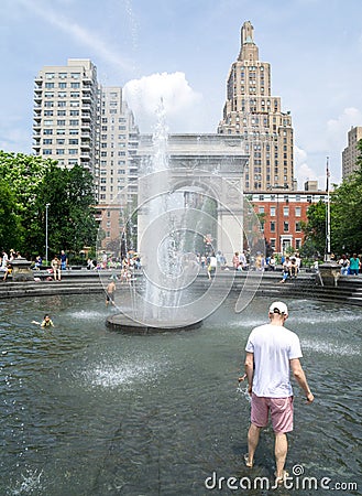 Beating the heat, jumping in the fountain at Washington square park. Editorial Stock Photo