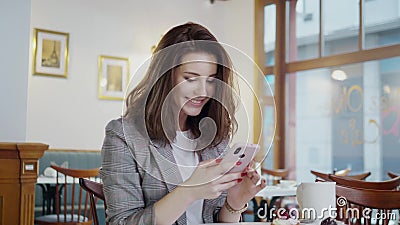 Beaufitul smiling girl with cell phone in a cafe Stock Photo