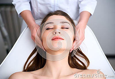 Beautician cleaning woman`s face. Spa skincare treatment. Cosmetologist with patient on medical chair. Healthy skin Stock Photo