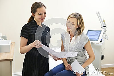 Beautician Discussing Treatment With Female Client Stock Photo