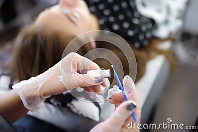 Beautician making eyelash lamination procedures. Modern eyelash care treatment procedures - staining, curling, laminating and Stock Photo