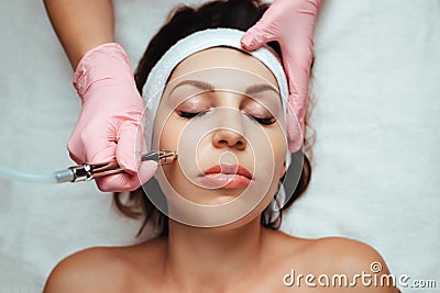 beautician performs microdermabrasion Stock Photo