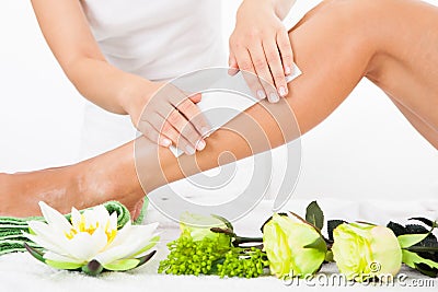 Beautician Waxing A Woman's Leg Stock Photo