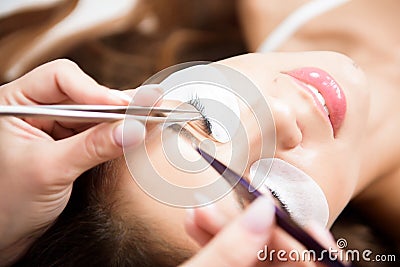 Beautician working on upgrading silk eyelashes in a beauty studio. Stock Photo