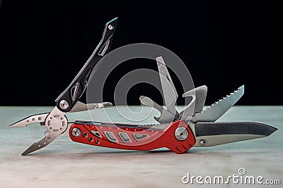 Beautifil red-black Multitool on white surface Black background Stock Photo