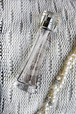 The beautifu autumn perfume bottle on white background and pearls beads Stock Photo