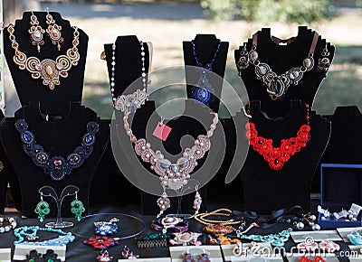 Beautiful accessory, necklace on a rack, earrings at the exhibition Stock Photo