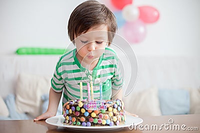 Beautiful adorable four year old boy in green shirt, celebrating Stock Photo