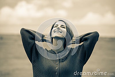 Beautiful adult girl in sweater at wheat field Stock Photo