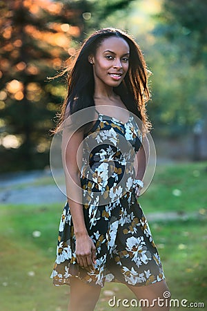 Beautiful african american smiling model woman walking in the city park Stock Photo