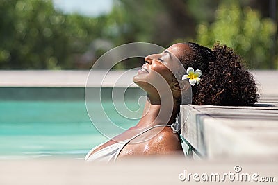 Beautiful african woman in pool relaxing Stock Photo