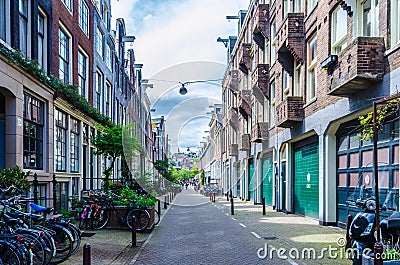 Beautiful alley alongside dutch houses in Amsterdam Netherlands Editorial Stock Photo