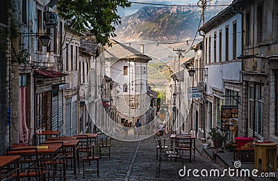 Beautiful alley in old town Gjirokaster on the background of the mountains, Albania Editorial Stock Photo