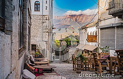 Beautiful alley in old town Gjirokaster on the background of the mountains, Albania Editorial Stock Photo