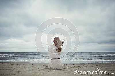 Beautiful alone girl on the beach Stock Photo