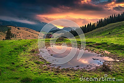 Beautiful alpine pasture with misty mountains at sunrise, Transylvania, Romania Stock Photo