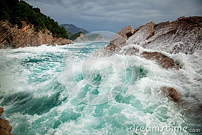 Beautiful amazing stunning seascape, waves crashing on rocks during a storm, Petrovac Montenegro Stock Photo