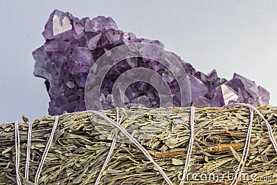 Beautiful Amethyst Crystal and a Sage Bundle Close Up Stock Photo