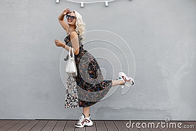 Beautiful amusing young stylish girl with a fashionable white Stock Photo