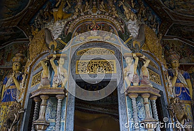 Beautiful ancient sculptures of saints neat the entrance in the holy buddhist temple Stock Photo