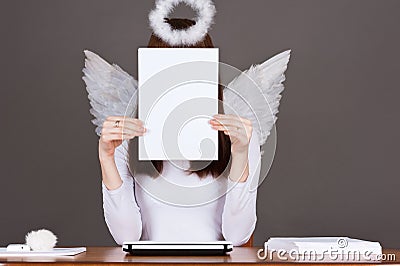 Angel sitting at a table Stock Photo