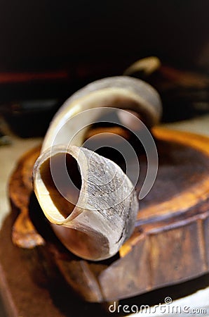 On the wooden board an antelope horn shofar Stock Photo