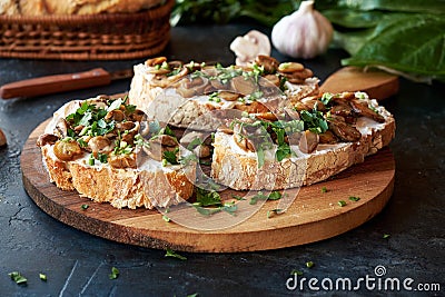 Beautiful appetizing bruschetta cream cheese and fried champignon mushrooms Stock Photo