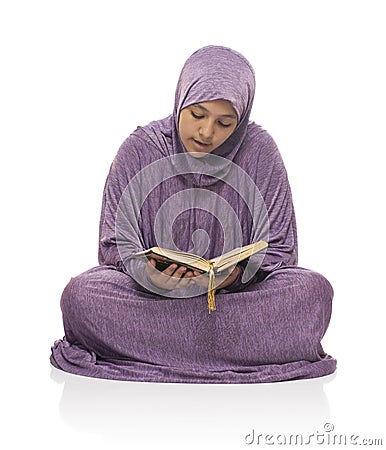 Beautiful Arab Muslim Girl Sitting Reading Holy Book of Quran Stock Photo