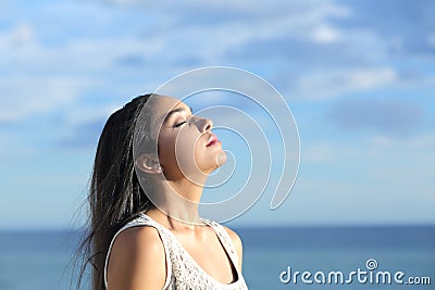 Beautiful arab woman breathing fresh air in the beach Stock Photo