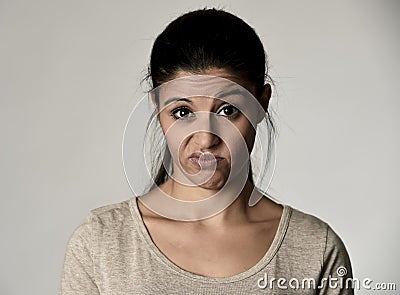 Beautiful arrogant and moody hispanic woman showing negative feeling and contempt facial expression Stock Photo