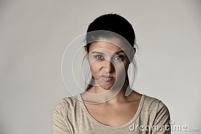 Beautiful arrogant and moody hispanic woman showing negative feeling and contempt facial expression Stock Photo