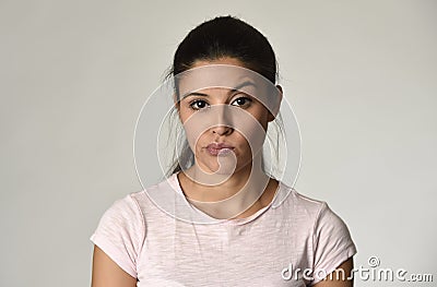 Beautiful arrogant and moody latina woman showing negative feeling and contempt facial expression Stock Photo