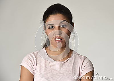 Beautiful arrogant and moody Mexican woman showing negative feeling and contempt facial expression Stock Photo
