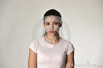 Beautiful arrogant and moody spanish woman showing negative feeling and contempt facial expression Stock Photo