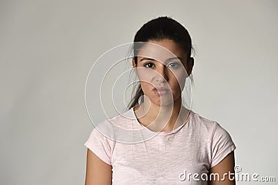 Beautiful arrogant and moody spanish woman showing negative feeling and contempt facial expression Stock Photo