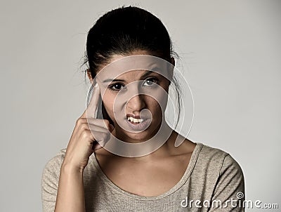 Beautiful arrogant and moody spanish woman showing negative feeling and contempt facial expression Stock Photo