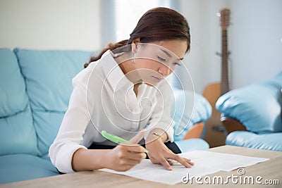 Beautiful Asian business women writing data checking document an Stock Photo