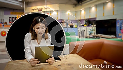 Beautiful asian businesswoman is looking at today's work plan with her work tablet. Stock Photo