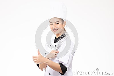 Beautiful Asian chef woman smile and holding Stainless balloon whisk isolated on white background Stock Photo