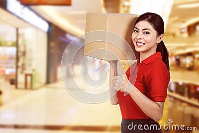 Beautiful asian female delivery holding the package Stock Photo