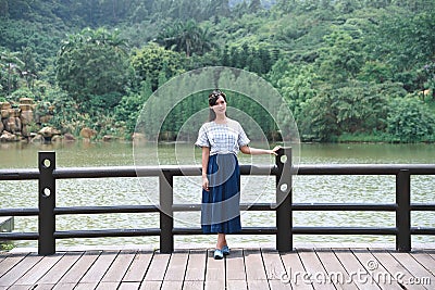 Beautiful Asian girl dressed in traditional elements dress showing herself Stock Photo