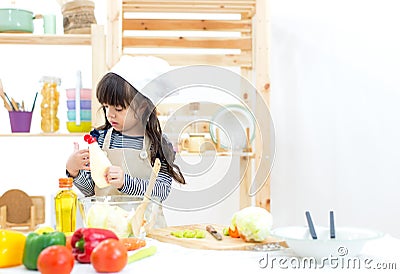 Beautiful asian girl kid making vegetable salad Stock Photo