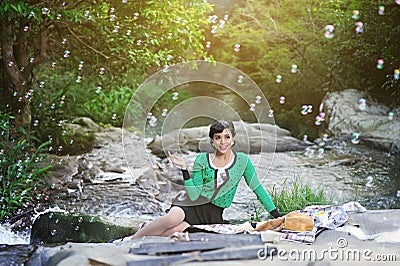 Beautiful Asian girl picnicking outdoors Stock Photo