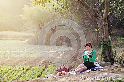 Beautiful Asian girl picnicking outdoors Stock Photo