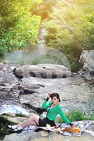 Beautiful Asian girl picnicking outdoors Stock Photo