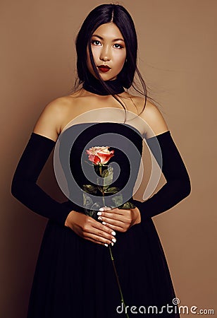 Beautiful asian look girl with black hair wearing elegant dress Stock Photo