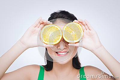 Beautiful asian portrait of young woman with oranges. Healthy food concept. Skin care and beauty. Vitamins and minerals Stock Photo