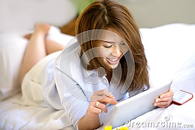 Beautiful Asian teenage smile with Ipad Stock Photo