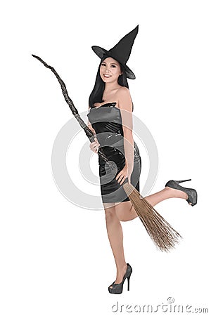 Beautiful asian witch woman with hat holding broom Stock Photo