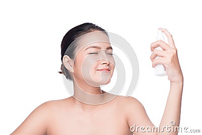 Beautiful asian woman applying spray water on face whit Stock Photo